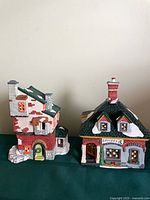 Front view of both ceramic village buildings side by side