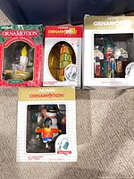 Group of four boxed NOMA Ornamotion ornaments