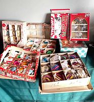 Overview of seven boxes of vintage glass ball ornaments