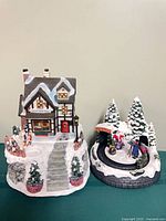 Both Christmas village pieces side by side