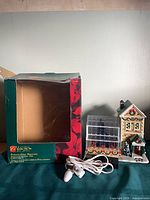 Front view of porcelain house with greenhouse and box