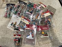 Group view of all sealed figurine packs spread on carpet