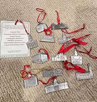 Group view of ten silver-tone Kingston building ornaments on carpet