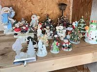 Shelf filled with assorted Christmas figurines in various styles