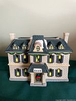 Front view of cream brick bank building with wreath and sign