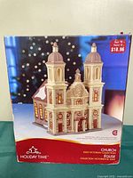 Front of box showing image of porcelain lighted church and branding