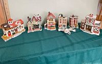 All six ceramic village buildings lined up on table