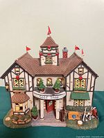 Front view of ceramic Golf Shop building with well, golf bag, flags, sign