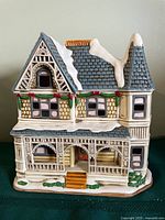 Front view of ceramic Victorian village house with snow detailing