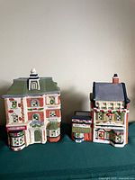 Both ceramic Christmas village buildings side by side