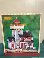 Front of sealed box showing Lemax Rocky Cape Lighthouse image