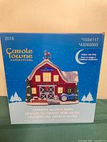 Front of sealed box showing product image, model numbers and dimensions