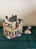 Front view of ceramic house showing porch, windows and attached cord