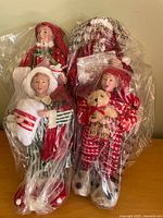 All four figurines in plastic bags