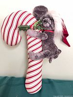 Front view of striped candy cane plush with koala attached