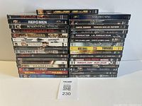 Full view of two stacks of 31 DVD cases with a MaxSold lot card