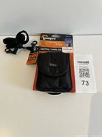 Front view of Lowepro Rezo 10 camera bag on retail card with strap visible