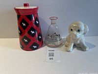 Canister, glass vase and puppy figurine grouped