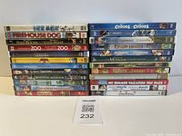 Two side-by-side stacks of DVD spines showing 21+ titles