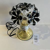 Lamp front view showing flower shades, base, cord