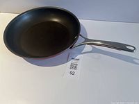 Full view of KitchenAid frying pan showing red exterior and stainless handle