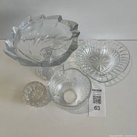 All four glass pieces grouped: pedestal compote, oval dish, medium ribbed bowl, small round dish