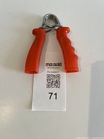 Front view of red hand grip exerciser