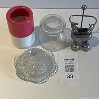 All four items grouped: phone stand, Ikea brush holder, glass jar, pressed glass dish