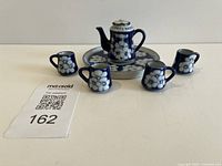 Entire six-piece miniature tea set arranged together
