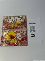 Front view of Hello Kitty and Pooh envelope packs