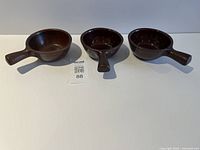 All three brown stoneware soup bowls with handles displayed side by side