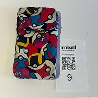 Front view of Poké Ball patterned pouch flap closed