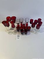 Front view showing all 21 ruby red glasses grouped by type