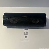 Front view of Samsung PS-JC2-1 center speaker with mesh grille and logo