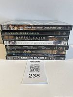 Stack of eight DVD cases showing visible spines