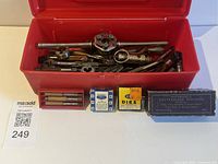 overall view of toolbox open with taps, dies, handles and boxed items in front