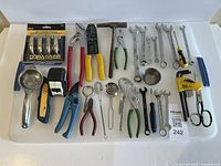 Overall view of all tools, wrenches, kitchen utensils and packaged door handles