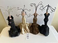 Front view of all four mannequin jewelry stands