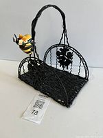 Front angled view showing basket shape, handle, bee accent