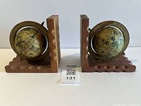 Front view of both wooden globe bookends