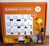 Front of sealed box showing Halloween cookie cutter set and shapes