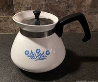 Side view of Corning Ware Blue Cornflower 6-cup teapot showing handle and lid