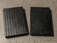 Two black Seagate portable hard drives with diamond pattern fronts