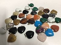 Group of assorted heart stone pendants spread out