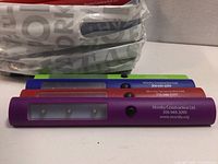 Four coloured LED light sticks stacked