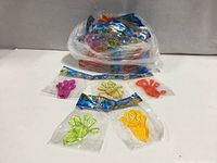 bag containing many individually wrapped sticky hand toys and several laid out in front showing colours