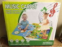 Front of Music Carpet box showing product image and features