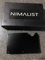 Box with Nimalist branding and wallet front plate