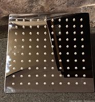 Front view of the stainless steel square shower head showing silicone nozzles