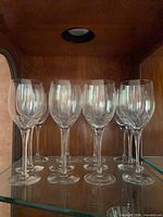Front view showing two rows of crystal goblets in cabinet